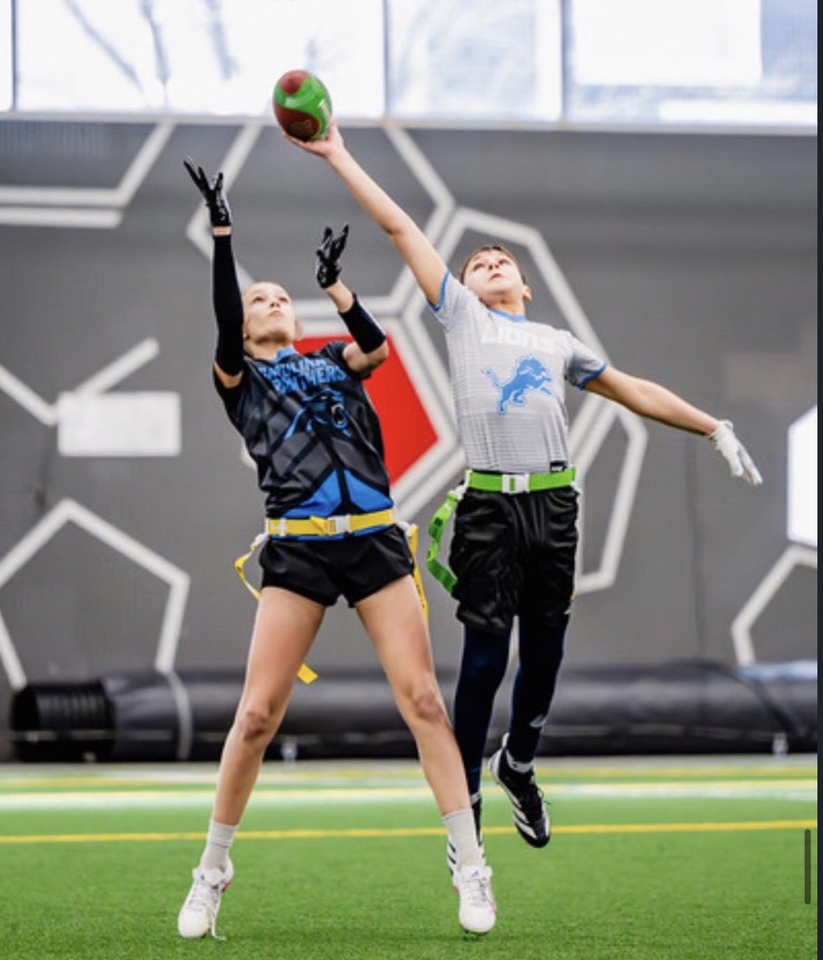 Two athletes leaping for a contested catch in the air
