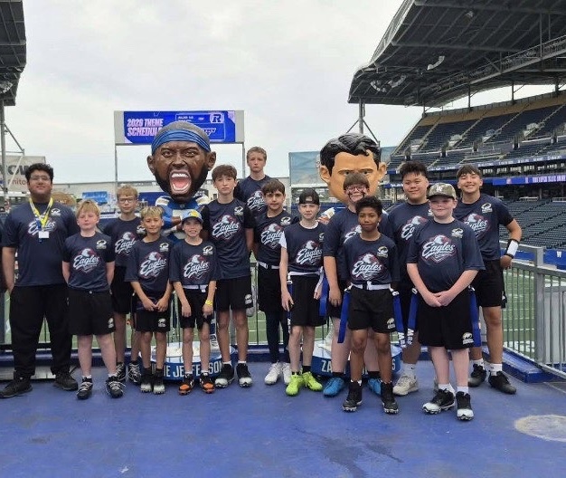Eagles youth players posing together in team shirts at the stadium