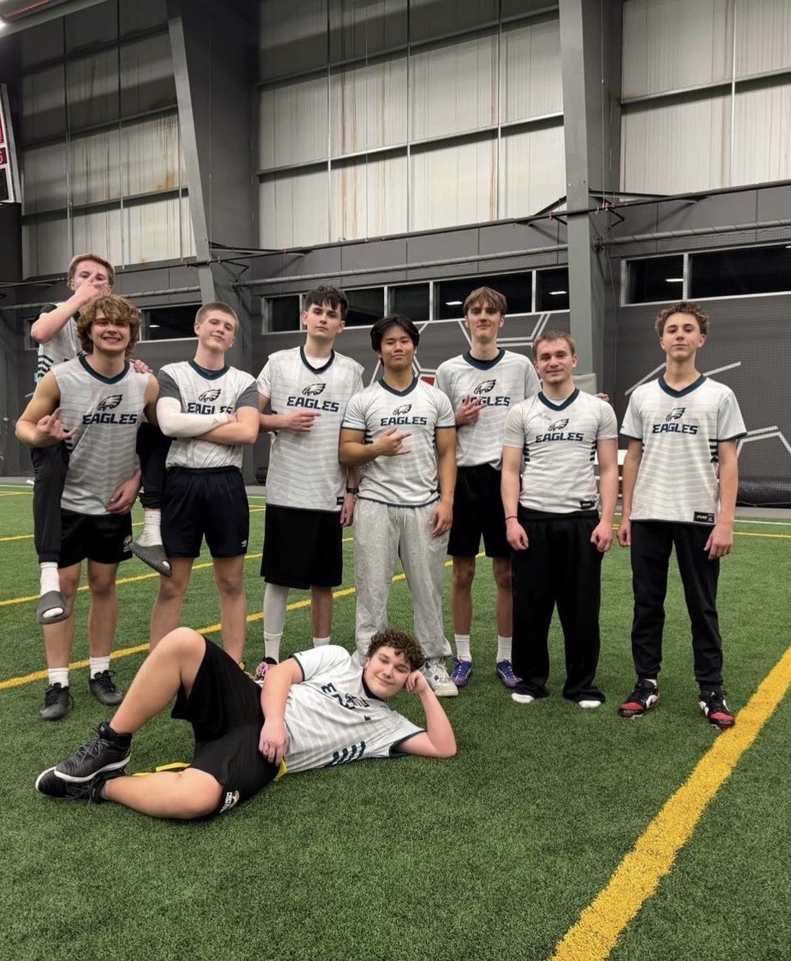 Eagles team group photo on indoor turf in team jerseys